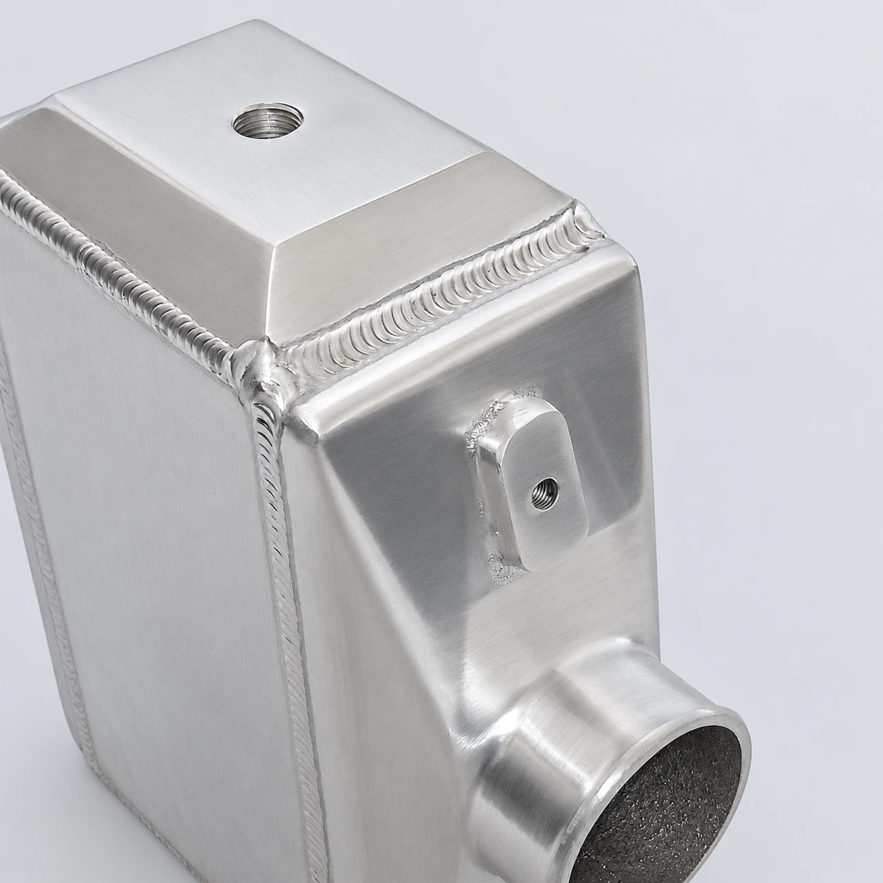 close-up · Threaded port, mounting boss and welds