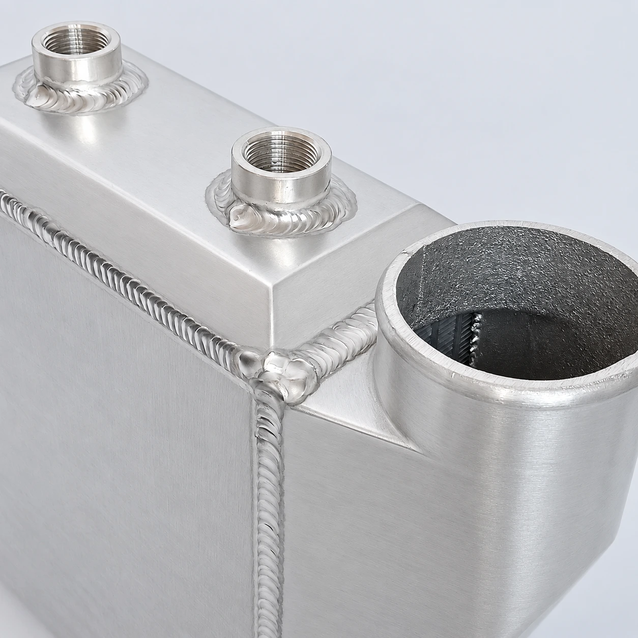close-up · Threaded coolant connections and welds
