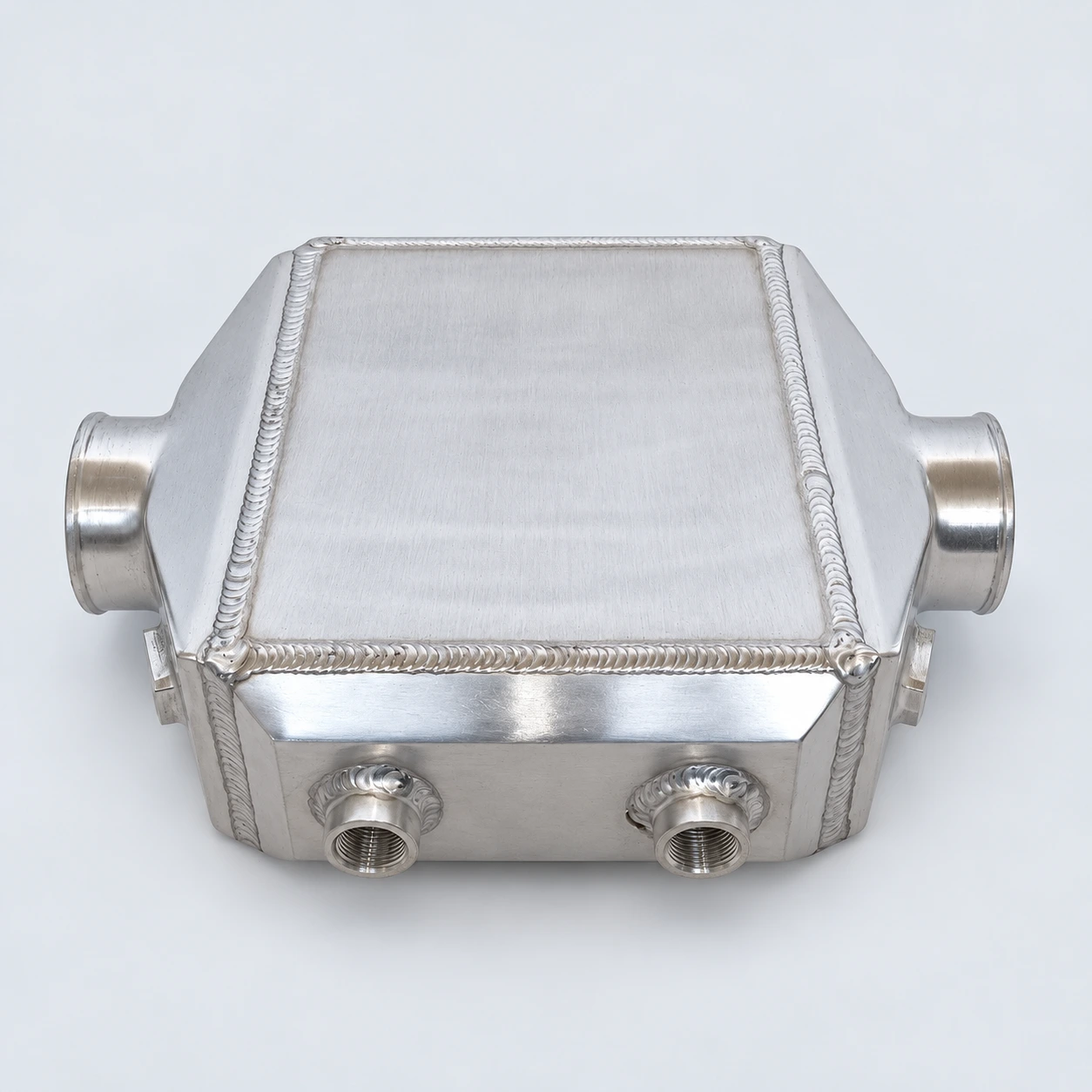 close-up · Threaded coolant connections and welds