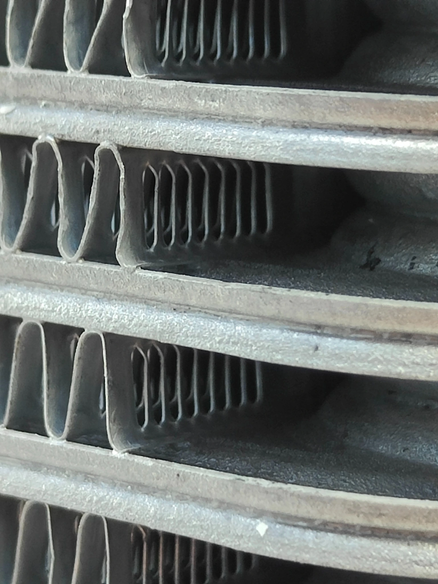 Open louver slots in the oil cooler air-passage fins after brazing