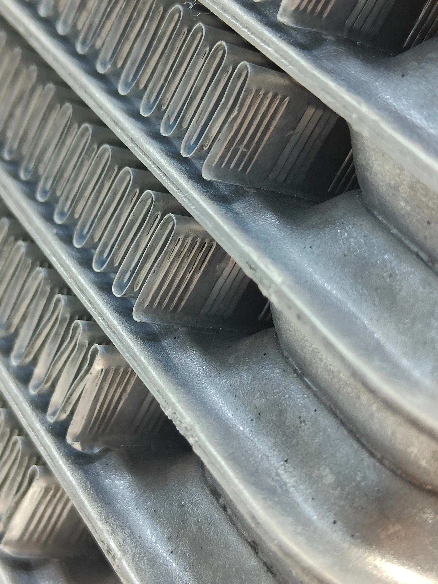 Angled detail of louver openings in brazed oil cooler air passages