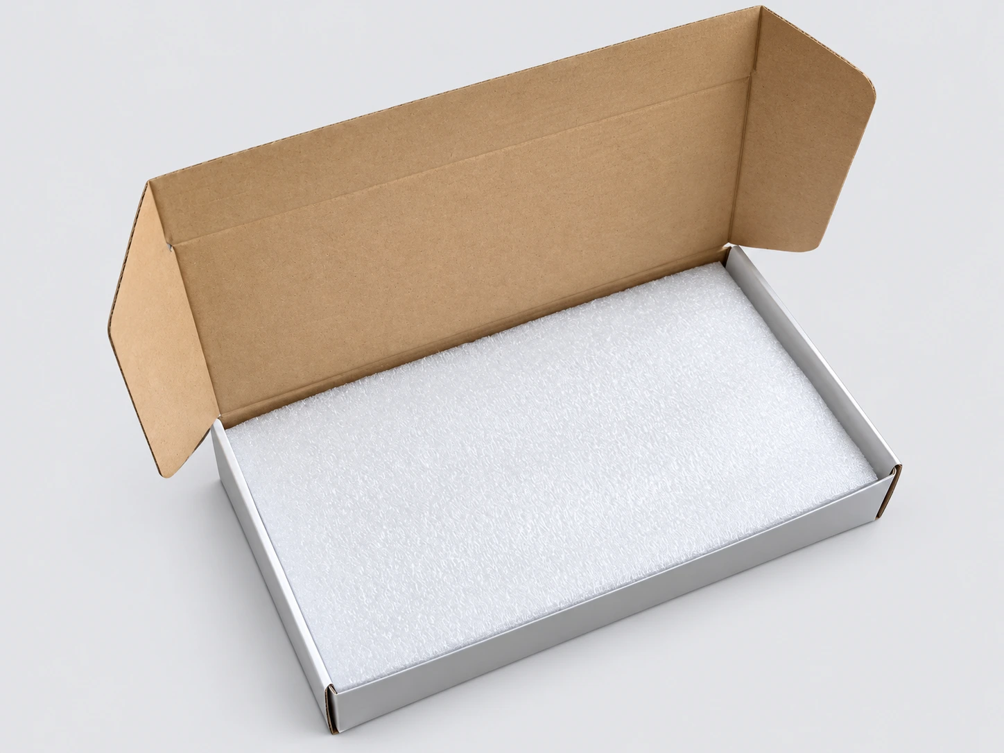 Protective white foam top cover over an oil cooler packed in its individual cardboard carton