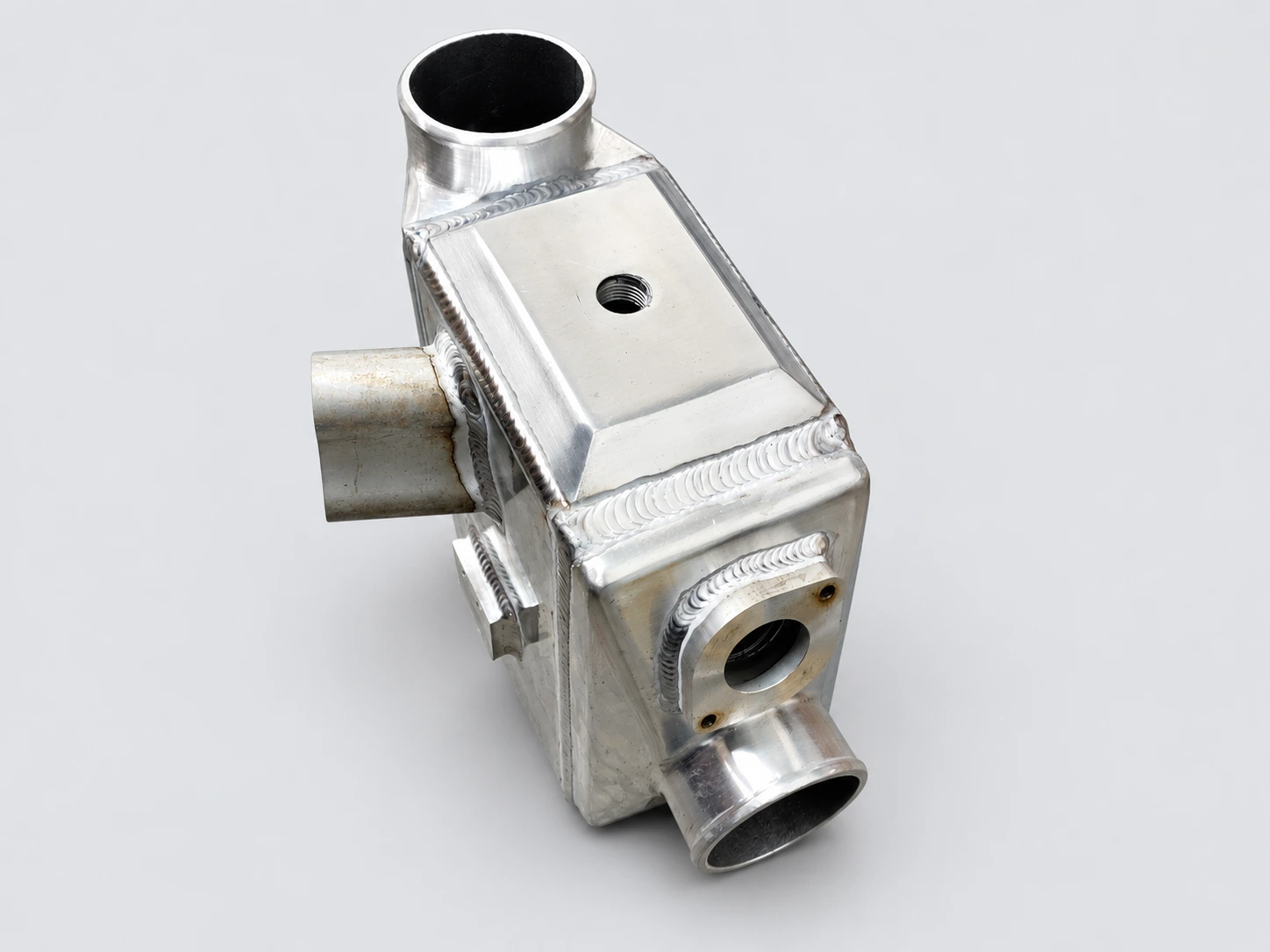 Yamaha 1.8L intercooler in natural silver aluminum, showing its ports, flanges and welds